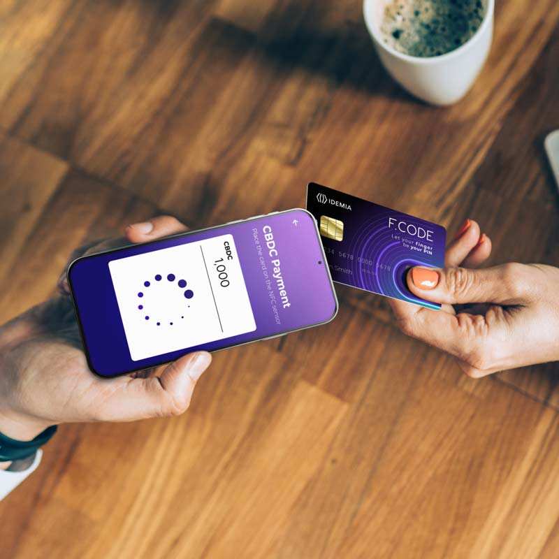 Mobile CBDC payment being made using a secure biometric card and smartphone interface