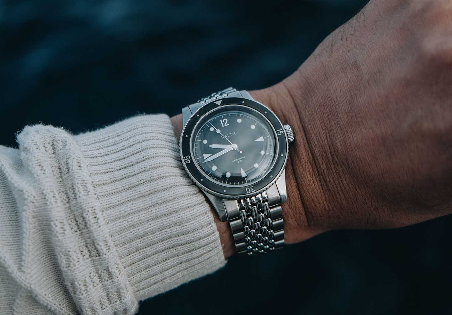 Close-up of a wrist wearing a Baltic Aquascaphe vintage diver watch with a stainless steel bracelet