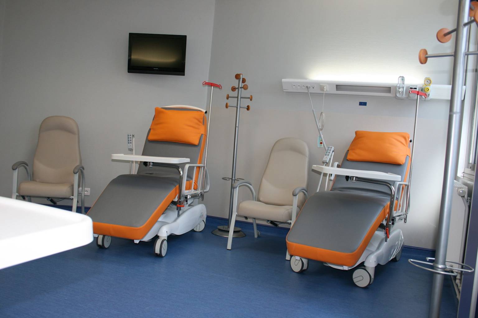A view of a modern ambulatory chemotherapy unit, featuring comfortable reclining chairs and patient amenities