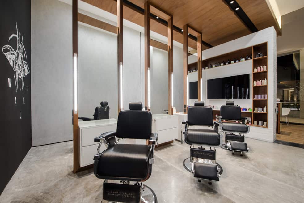 A modern and clean barbershop interior featuring multiple styling stations, highlighting a professional and hygienic setting.