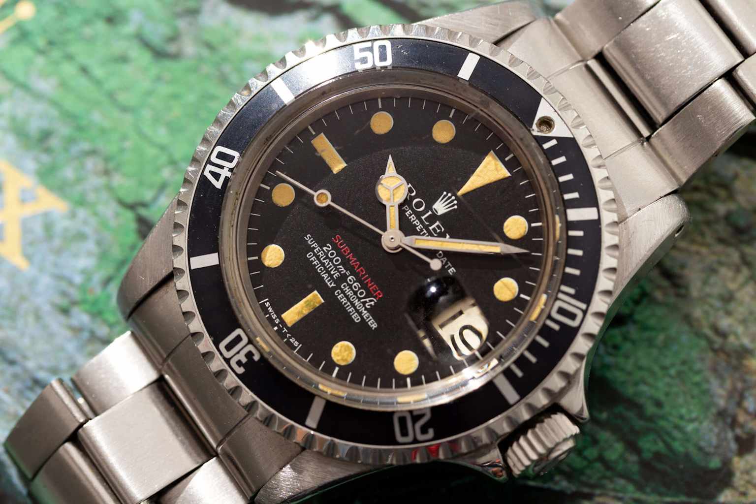 A vintage Rolex Submariner Ref. 1680, distinguishable by its red 'SUBMARINER' text and classic design
