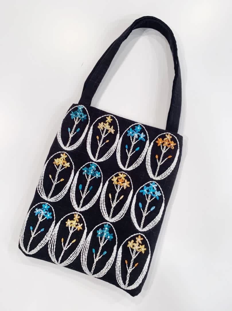 Handmade black fabric handbag with colorful floral embroidery from 勝野洋輔's brand collection