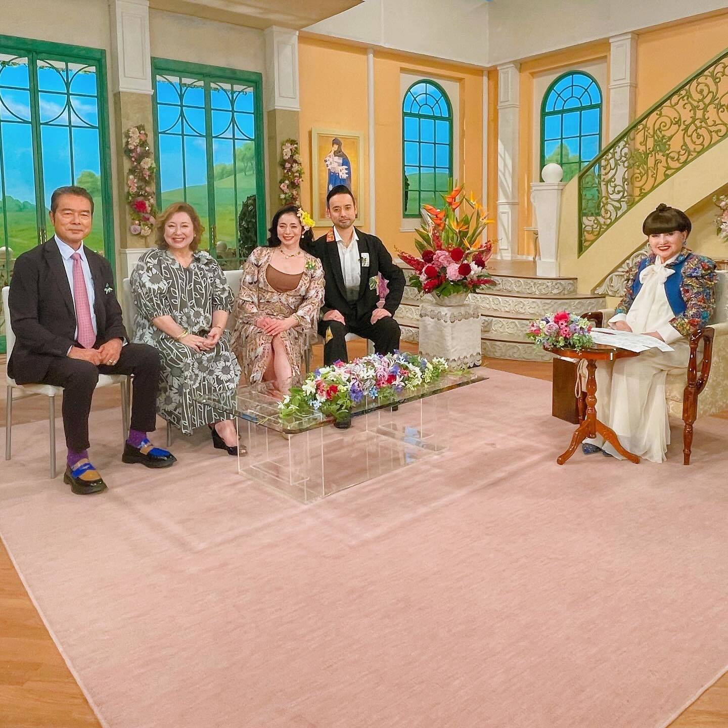 Guests including 勝野洋輔 on the set of the Japanese talk show "徹子の部屋" in a warm, floral-decorated studio setting