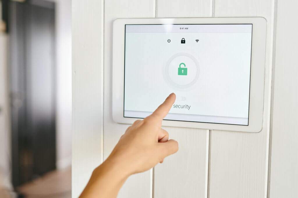 Modern home security system control panel showing an unlocked status, highlighting the importance of checking and maintaining alarm systems before vacation