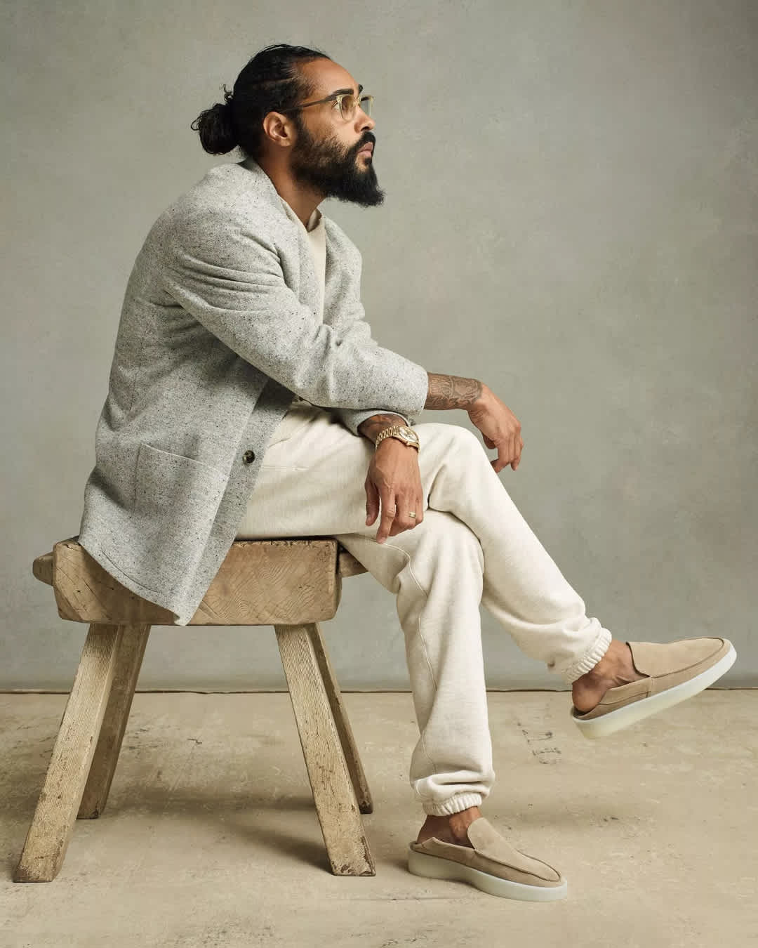 Jerry Lorenzo demonstrates a balanced luxury streetwear look, pairing refined outerwear with comfortable sweatpants and stylish backless loafers