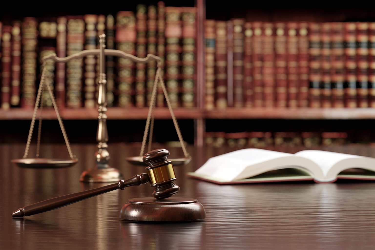 Judge's gavel, balance scale, and open law book symbolizing justice and legal authority