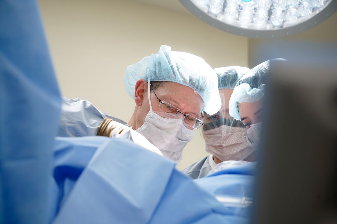 A surgical team focused on a procedure in an operating room