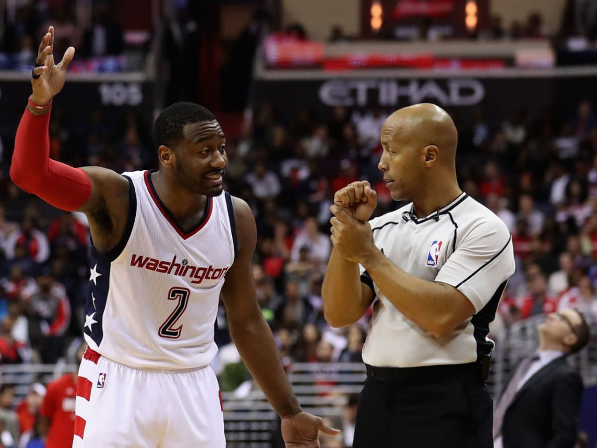 Washington Wizards player John Wall in discussion with an NBA referee during a basketball game