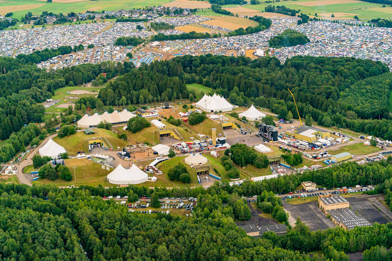 Aerial view of the Nature One Festival site in Kastellaun showing festival tents, camping areas, and surrounding forest