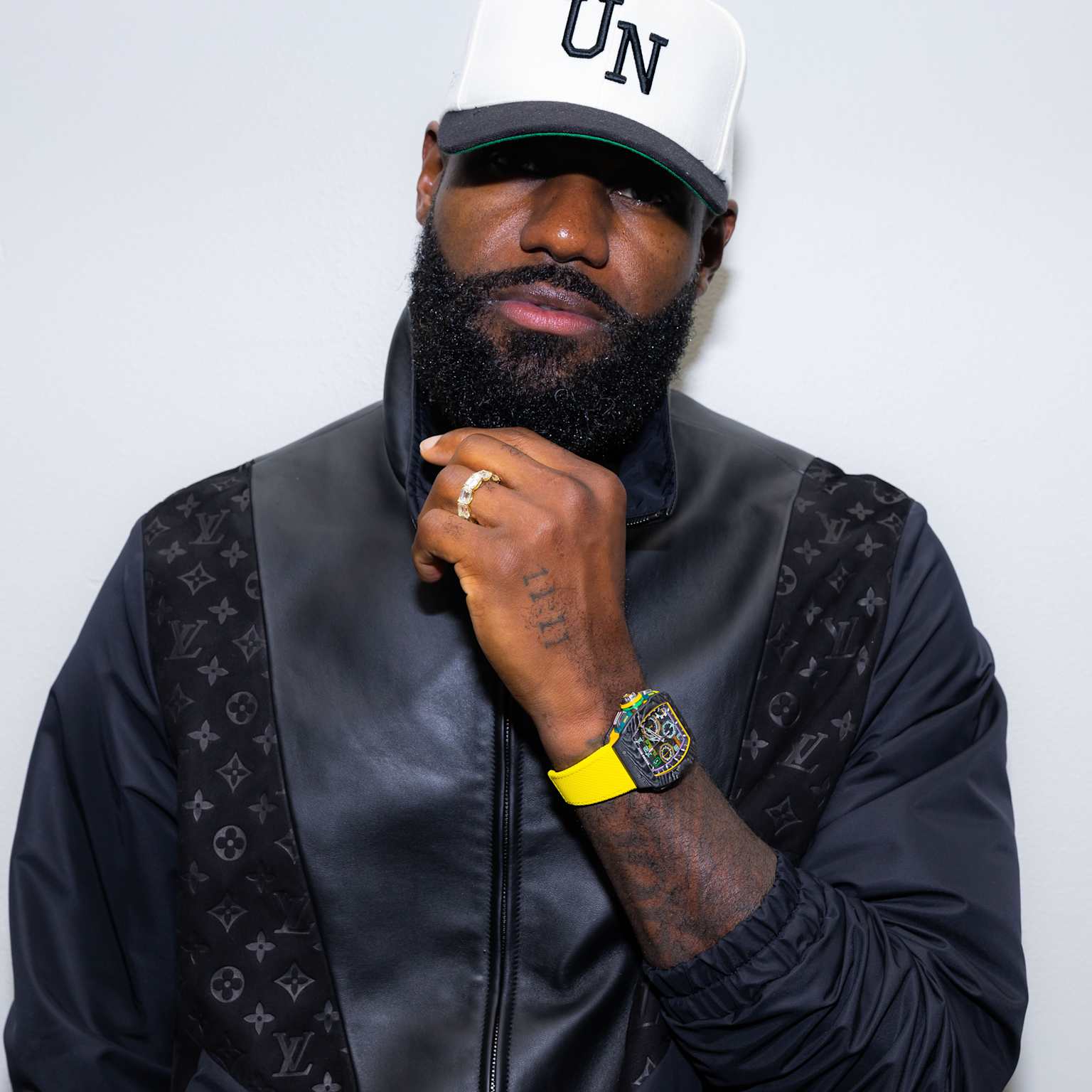 LeBron James wearing a Richard Mille RM 65-01 watch with a vibrant yellow strap and a black Louis Vuitton jacket