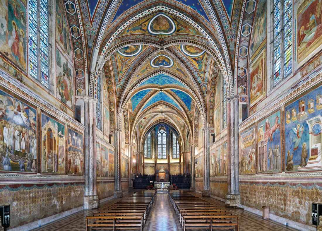 Interior view of the Basilica of Saint Francis of Assisi, featuring its intricate frescoes and vaulted ceilings