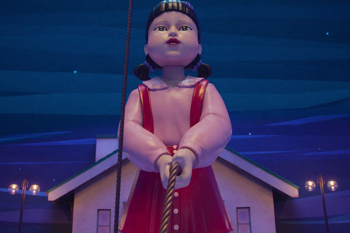 The iconic 'Red Light, Green Light' doll from *Squid Game*, symbolizing the series' deadly children's games.