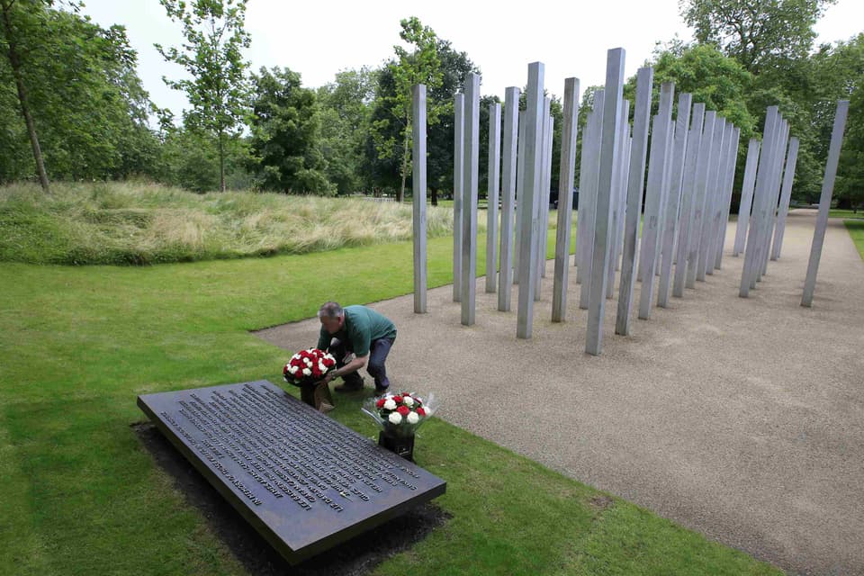 A man places a floral wreath at the 7/7 London Bombings Memorial in Hyde Park, commemorating the victims of the attacks