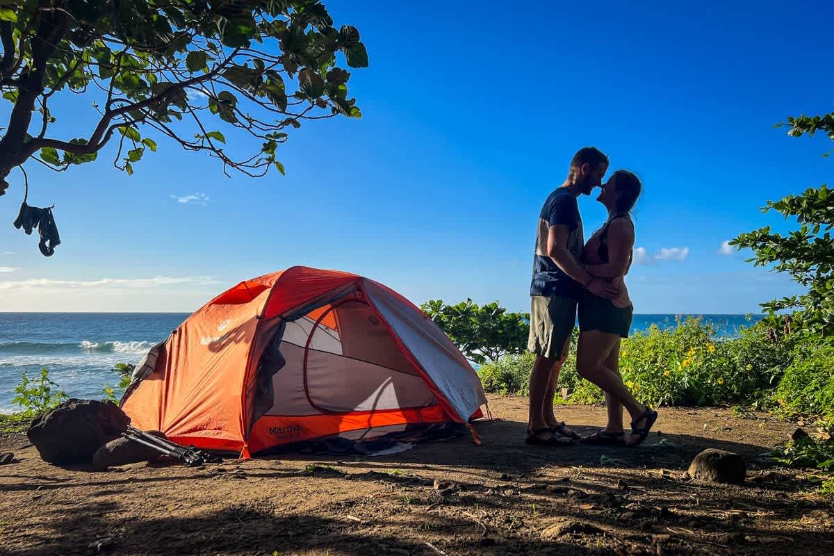 A tent set up by the ocean shore, showcasing a budget-friendly way to experience Hawaii