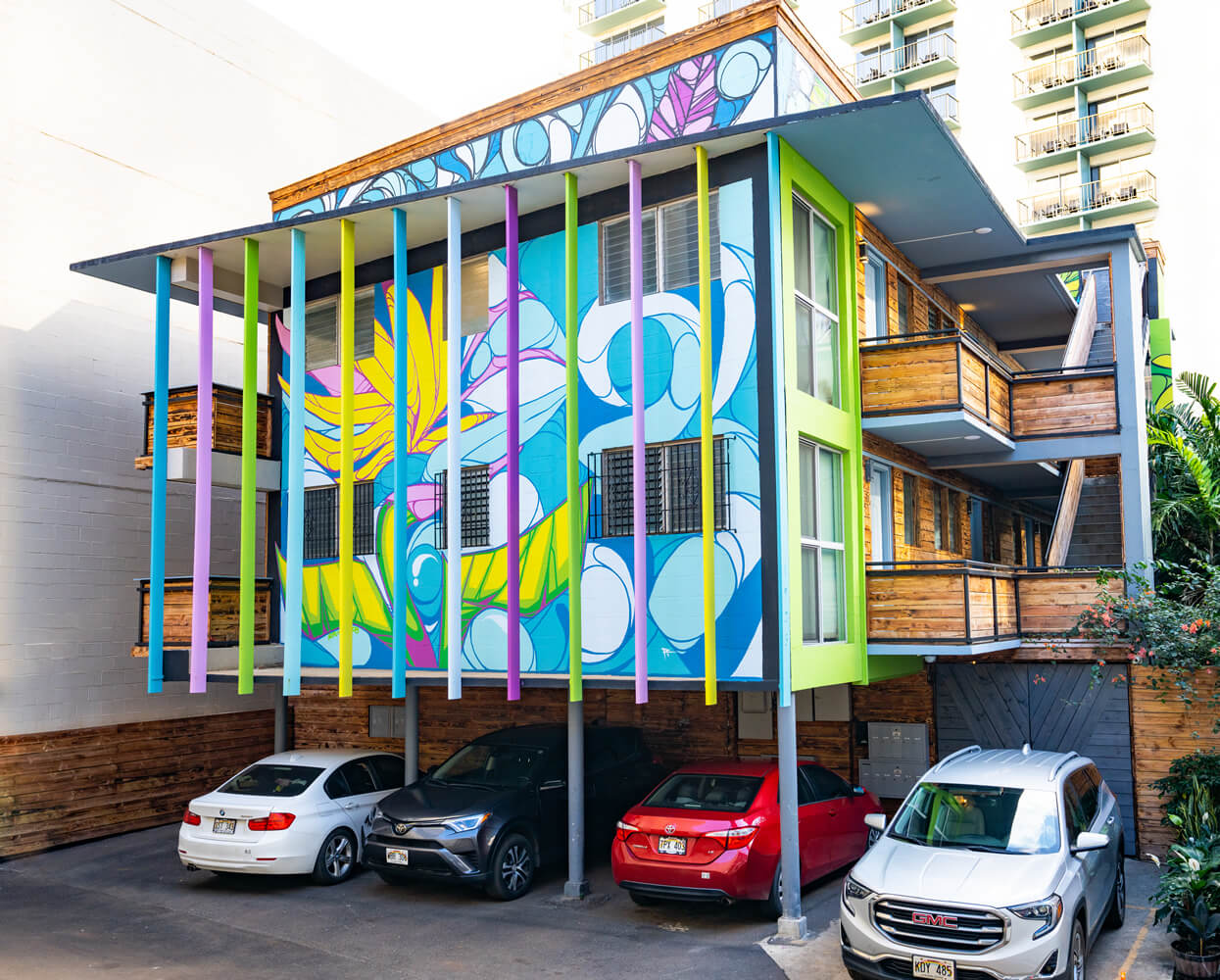 The vibrant exterior of the Honu Waikiki Hostel, a budget-friendly lodging option in Waikiki