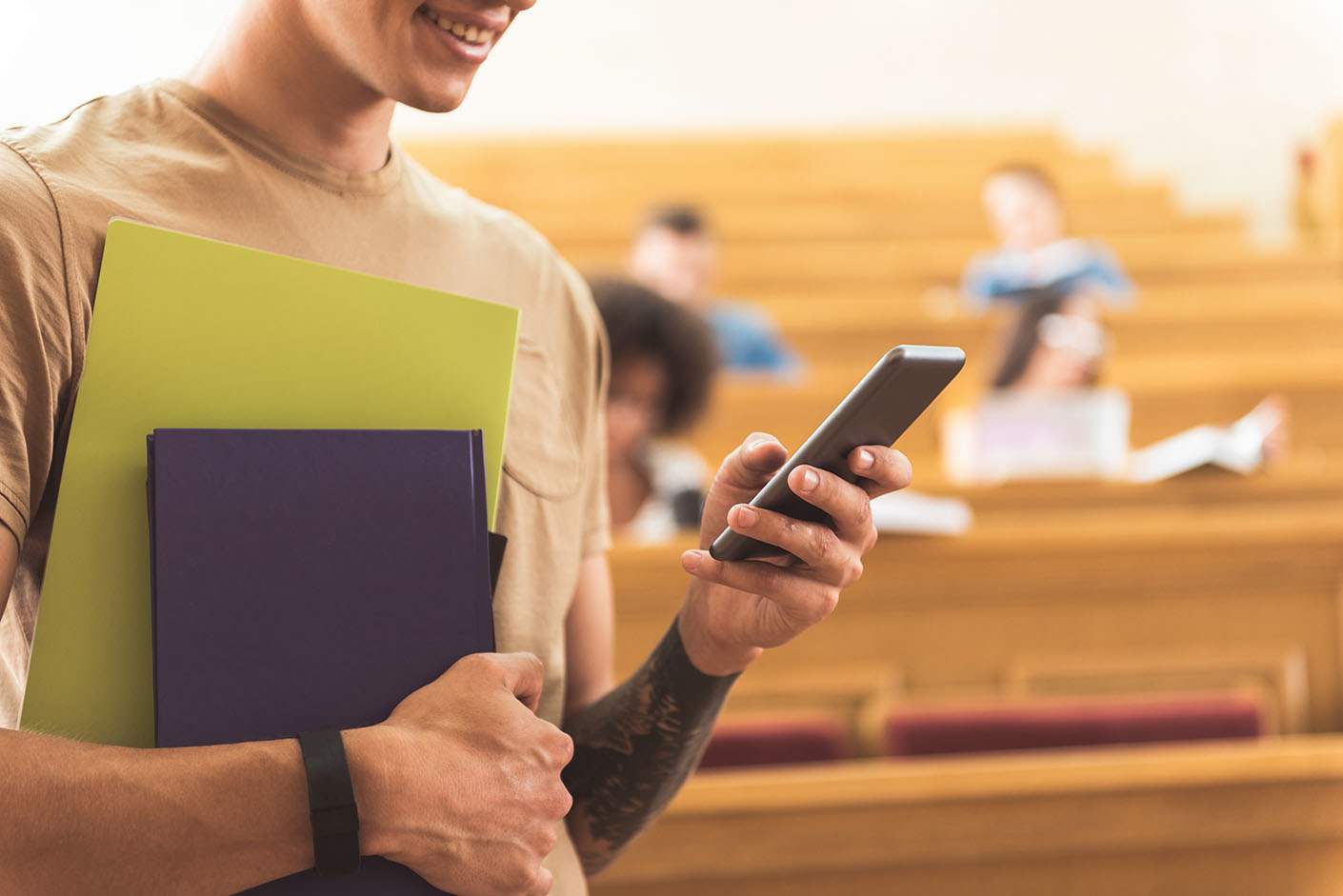 A person uses a smartphone in a lecture hall, embodying daily digital engagement and potential interaction with productivity tools.