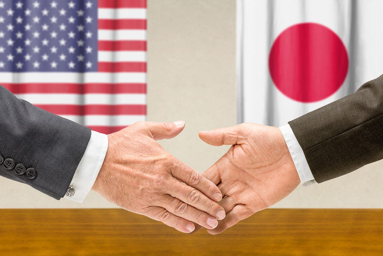 Handshake between U.S. and Japan representatives symbolizing trade negotiations and business relations
