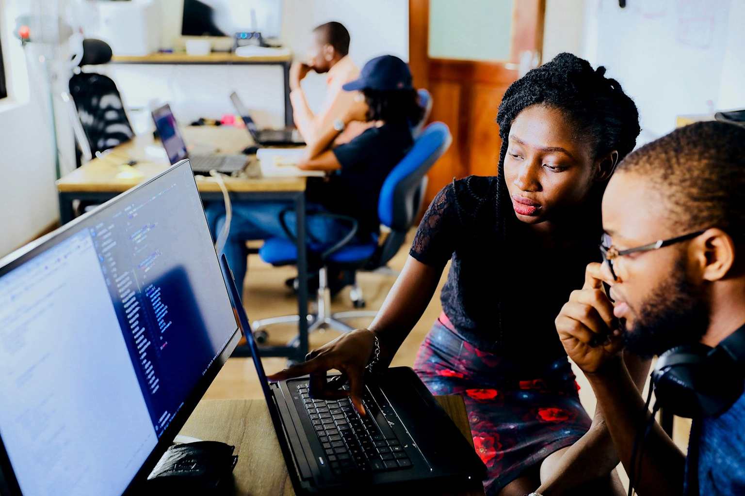 African individuals engaged in technology-driven collaboration, highlighting the role of ICTs in modern education