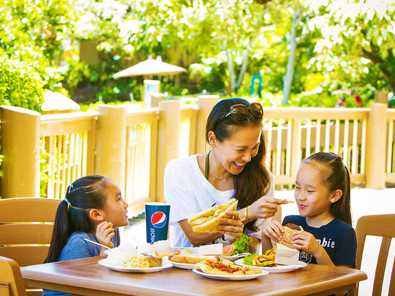 A family shares a meal at Kau Kau Kitchen within Sea Life Park Hawaii