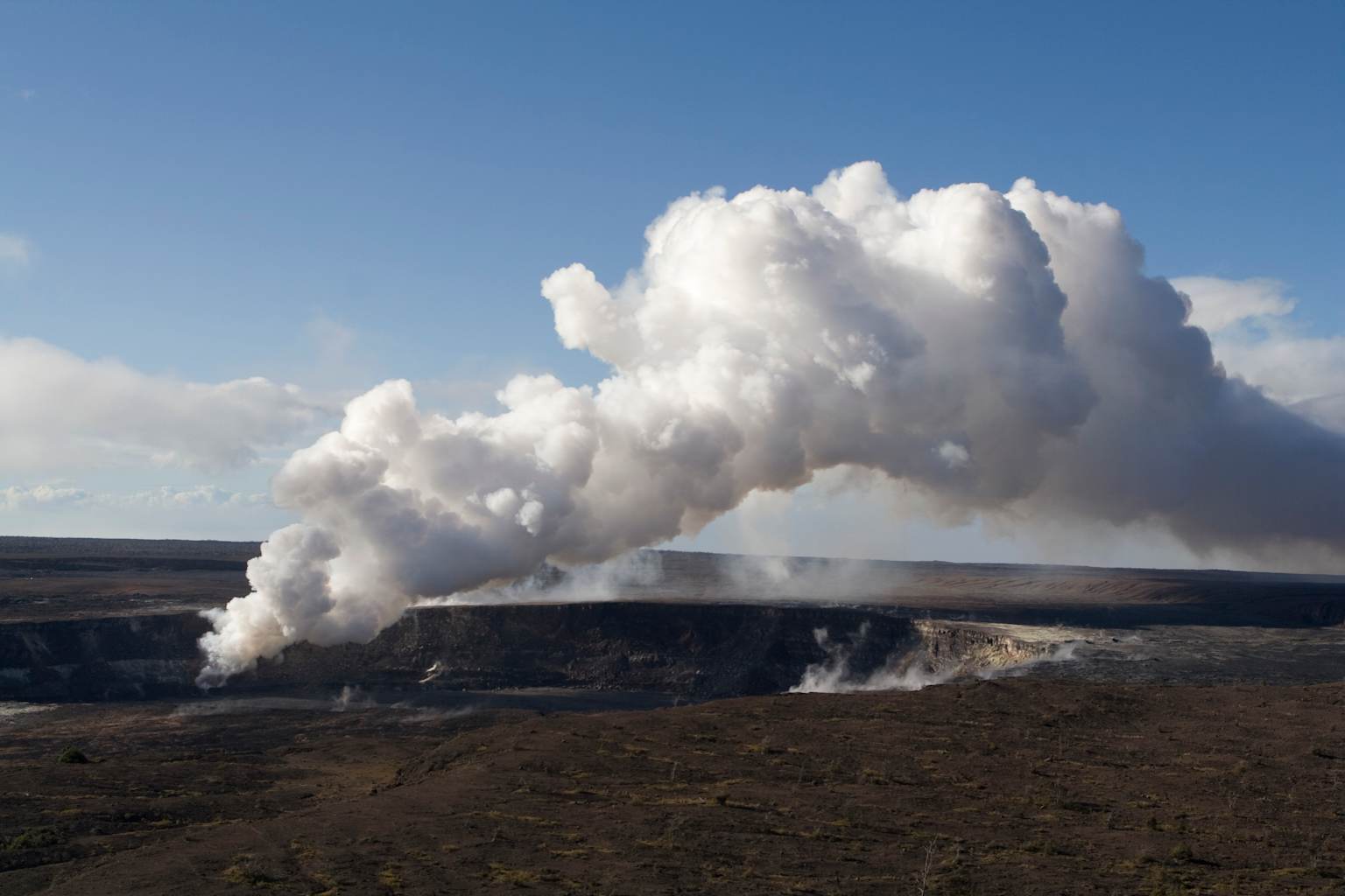 A volcanic gas plume rises from the Halema'uma'u crater within Kīlauea volcano's summit caldera