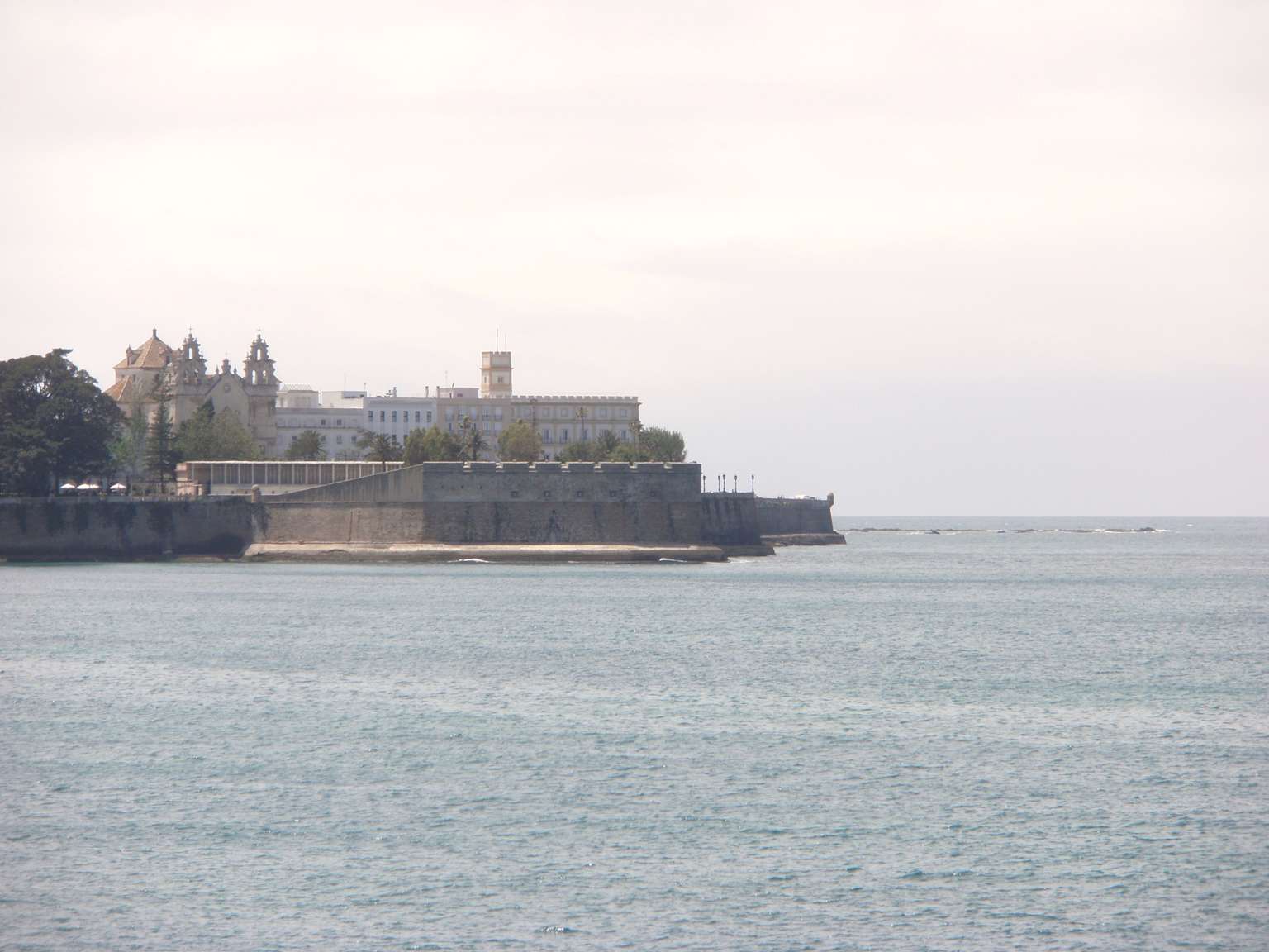 Coastal view of the Baluarte de la Candelaria historic fortress in Cádiz, Spain