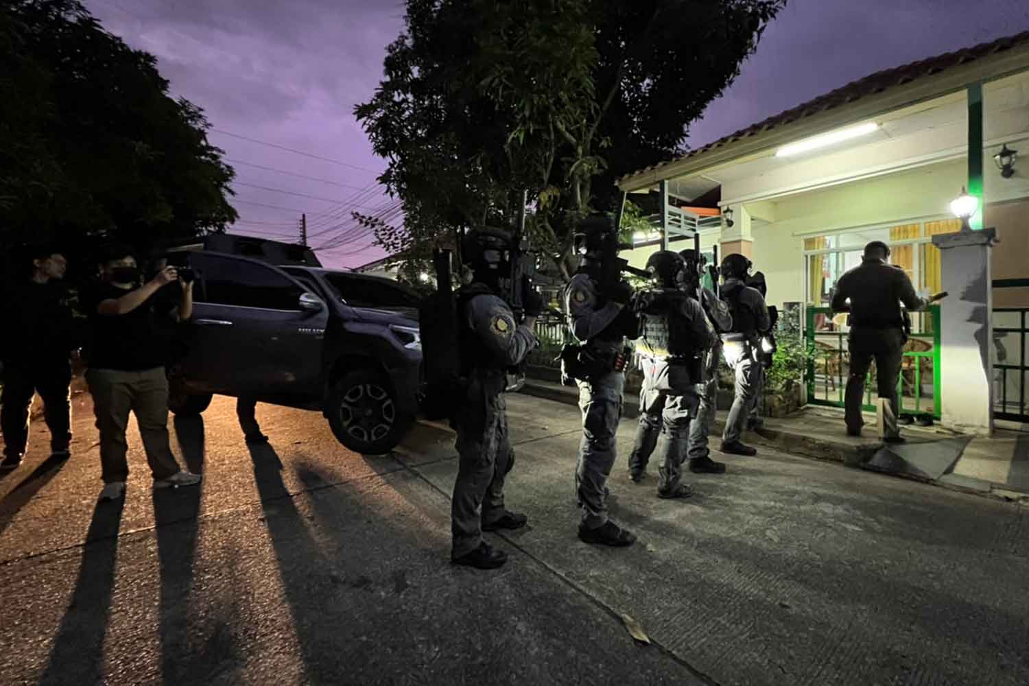 Law enforcement officers conduct a raid during a crackdown on illegal gambling operations