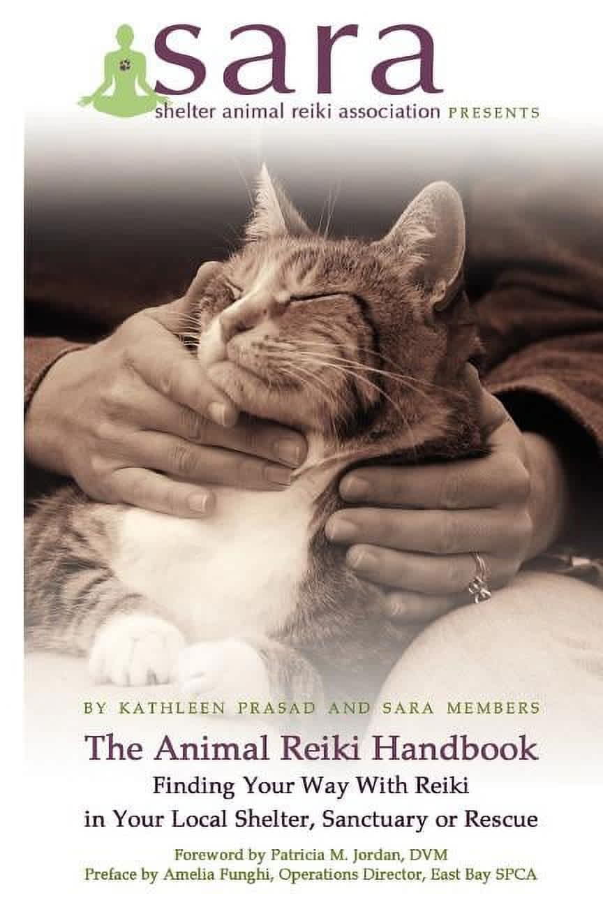 Book cover for "The Animal Reiki Handbook" illustrating hands-on reiki with a cat, highlighting its use in shelters and rescue organizations.