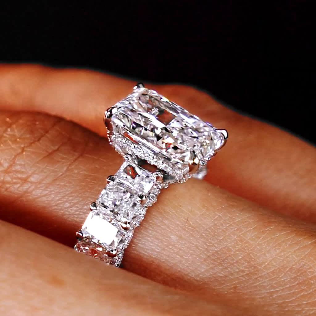 Close-up of a radiant-cut lab-grown diamond engagement ring with micropavé setting
