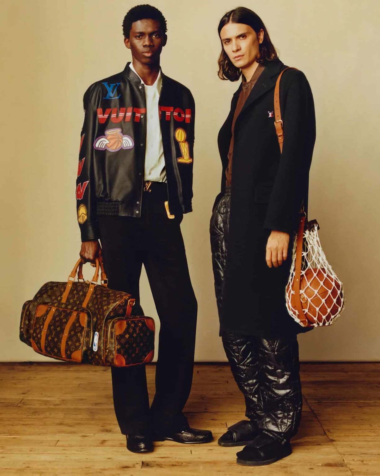 Louis Vuitton showcases luxury streetwear with a varsity jacket, monogram duffel bag, and basketball accessory