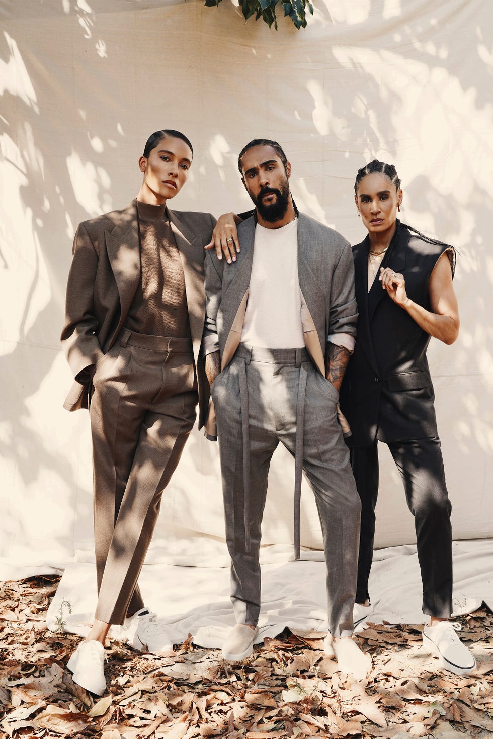 Models showcase luxury streetwear looks, blending tailored pieces with casual elements and sneakers, emblematic of Fear of God's aesthetic
