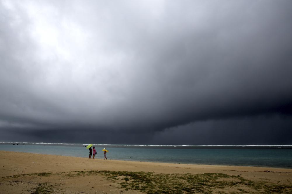 Stormy skies over a Hawaiian beach remind visitors that the islands experience more than just sunshine and perfect weather