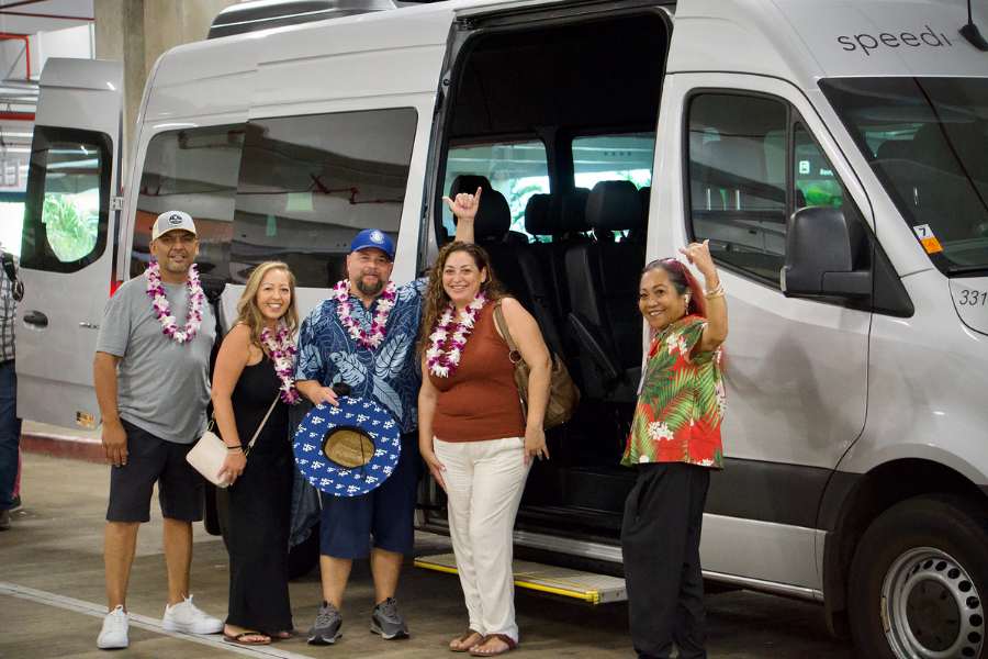 Tourists arriving in Hawaii using a shuttle service as an alternative to renting a car for airport transfers and group travel