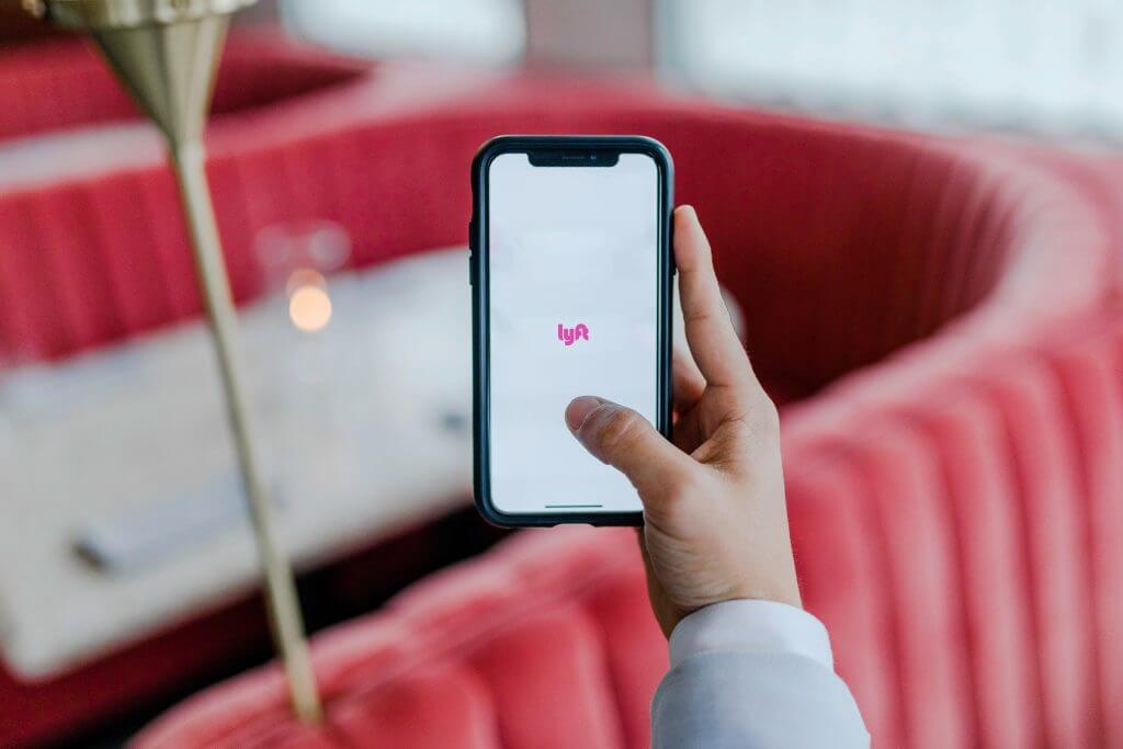 Smartphone displaying the Lyft app, highlighting rideshare options as an alternative to renting a car in Hawaii