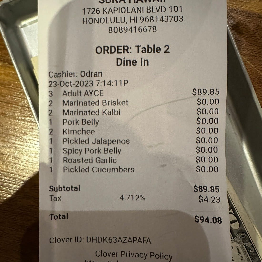 Receipt from Sura Hawaii in Honolulu showing a $94.08 bill for an all-you-can-eat dinner, illustrating the high cost of dining out for tourists