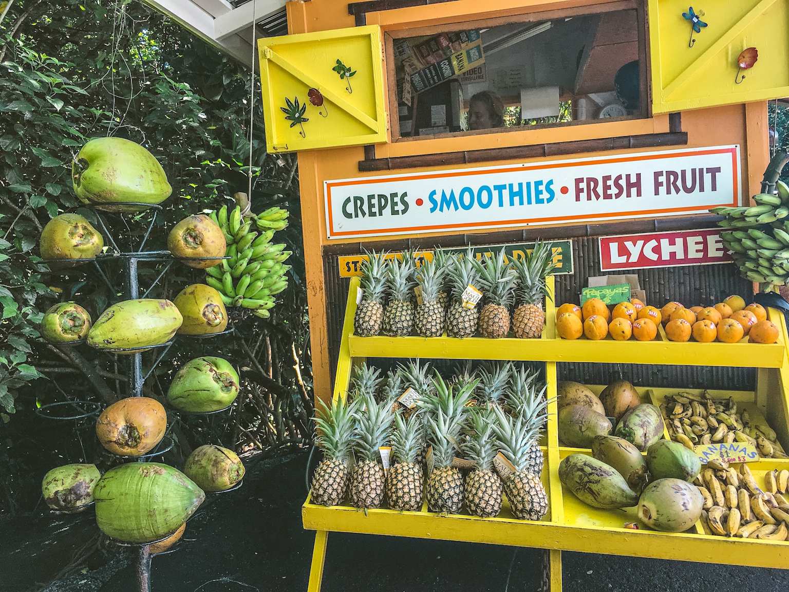 Fresh tropical fruit stand in Hawaii offering crepes, smoothies, and fresh fruit, showcasing local affordable dining options