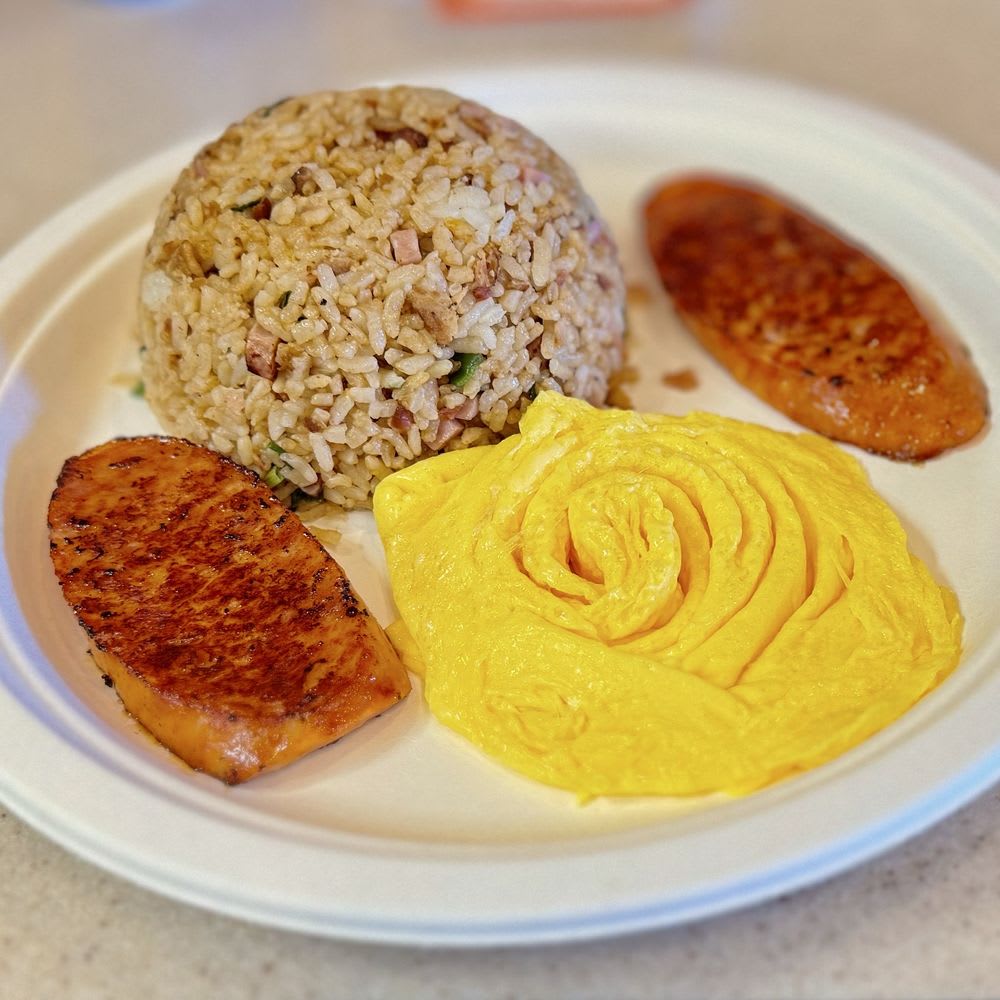 Hawaiian local breakfast plate with fried rice, grilled Spam, and fluffy egg omelette representing affordable island dining