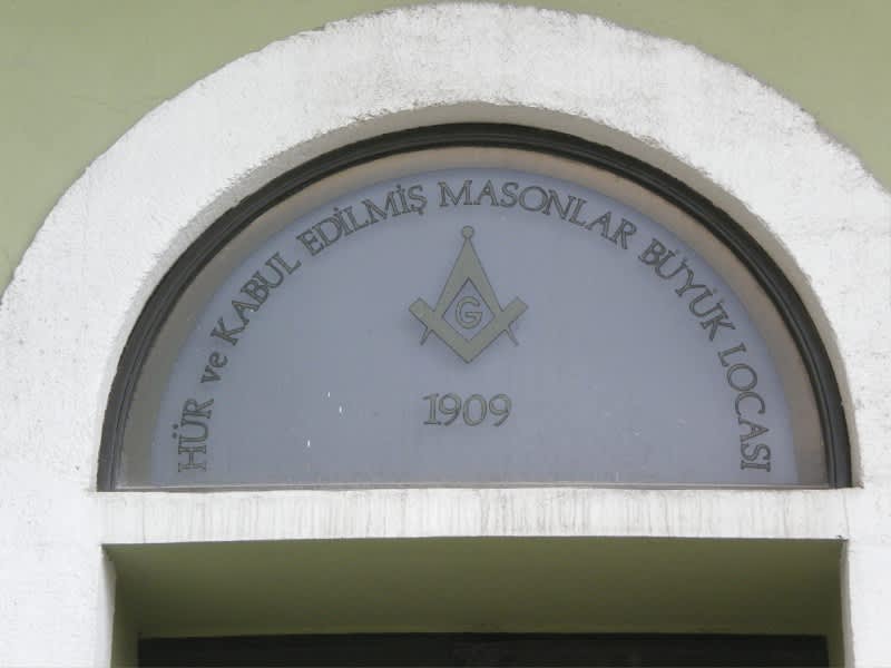 Entrance window of a Masonic lodge in Turkey with the symbol and founding year 1909.