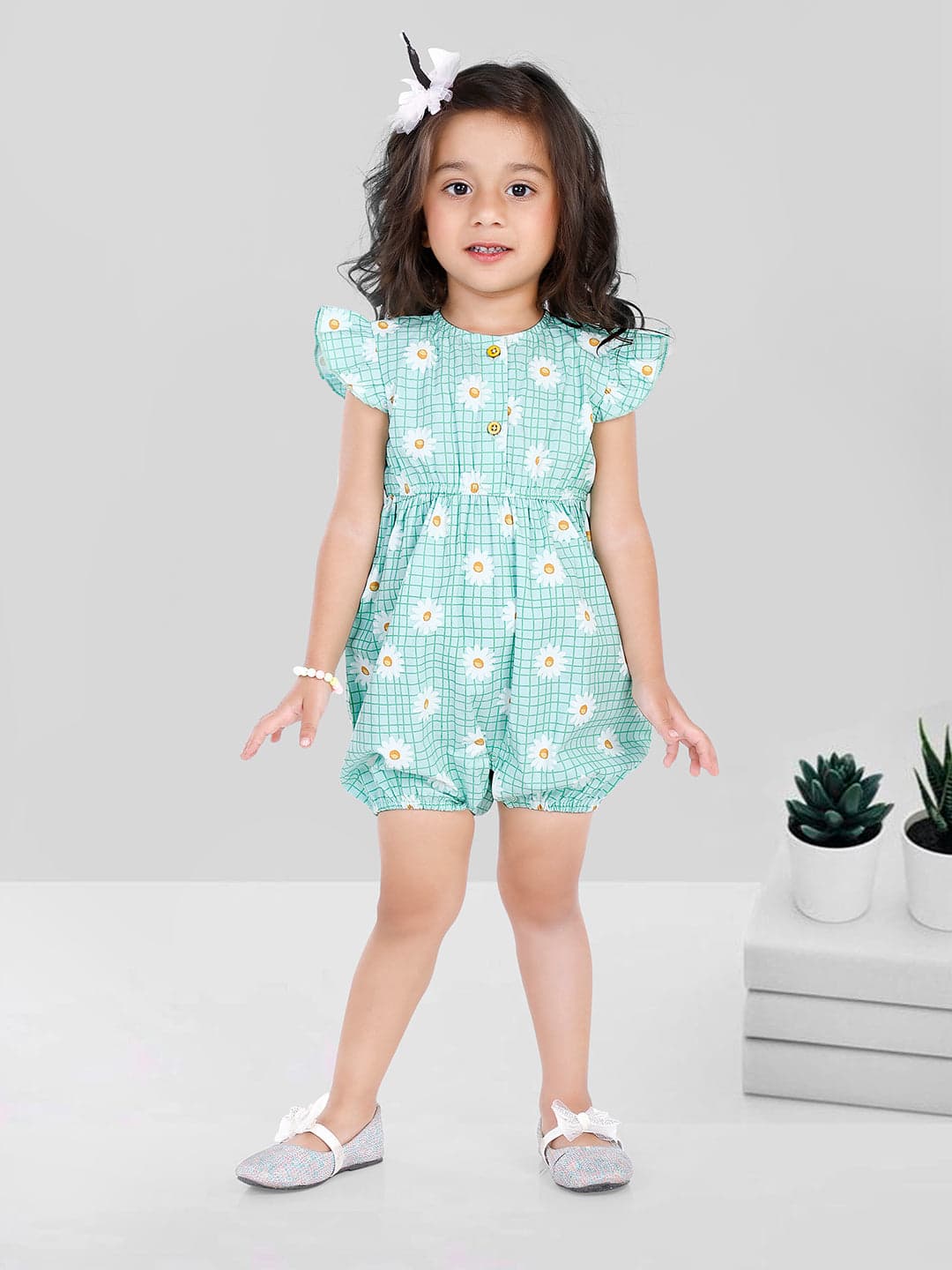 Child in daisy-patterned romper