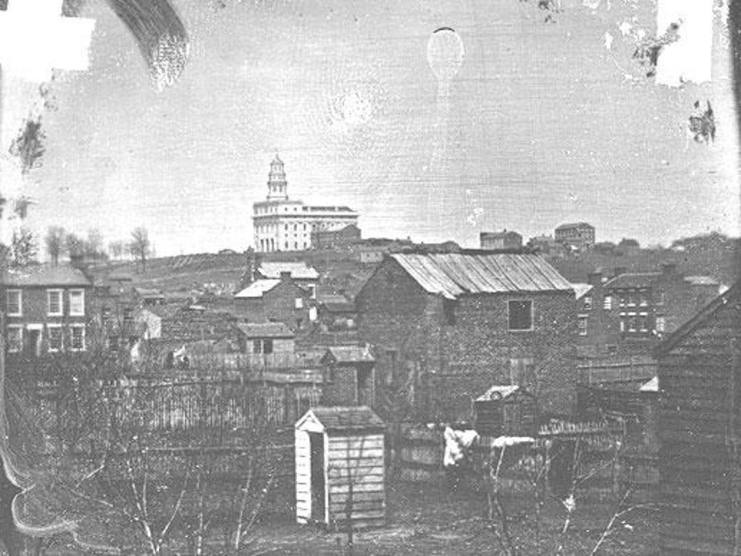Historic 1840s photo of Nauvoo, Illinois, featuring the early Mormon settlement and the prominent Nauvoo Temple on the hill.