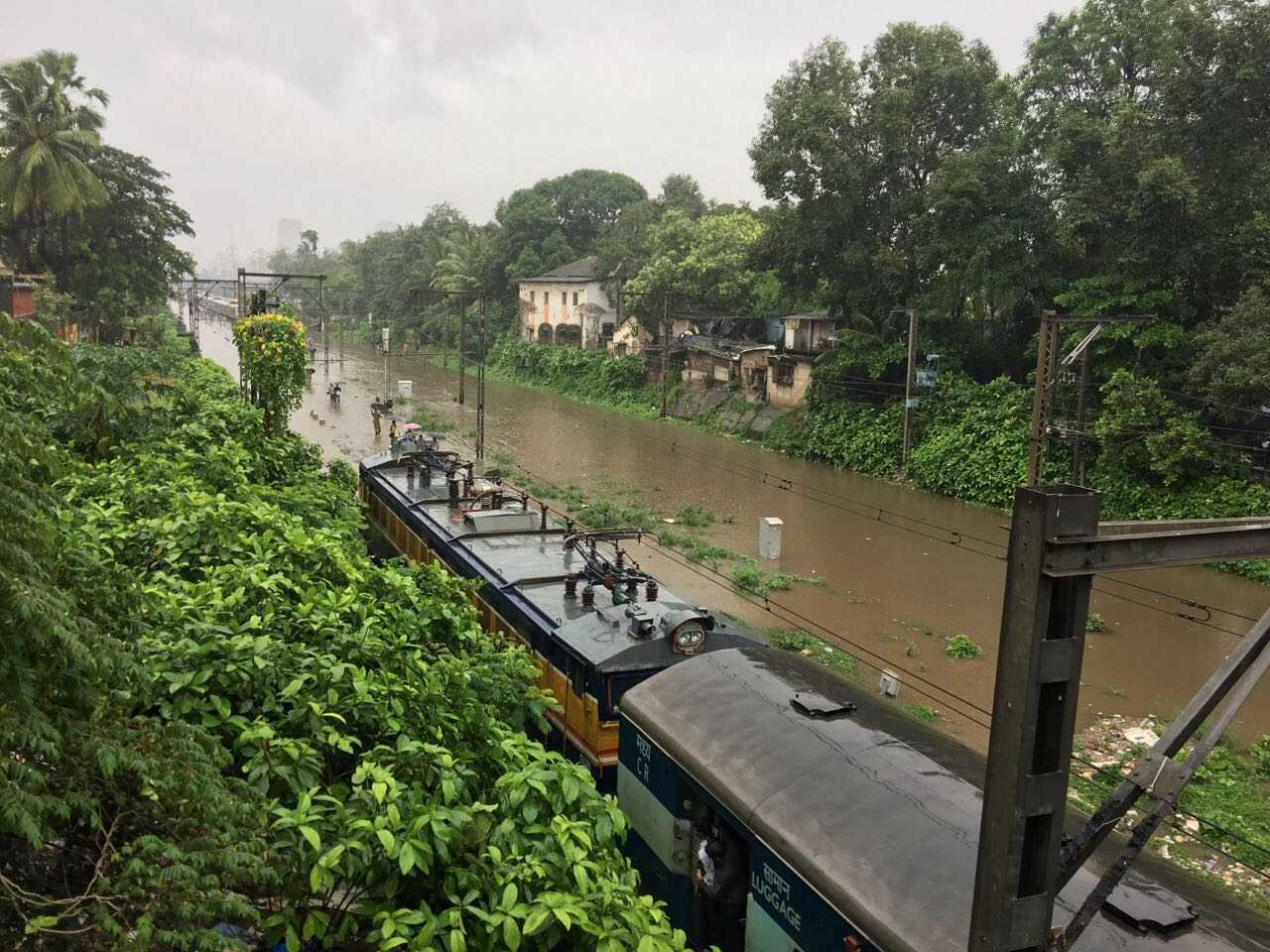 Mumbai monsoon flooding impacting local railway tracks and daily commuter life