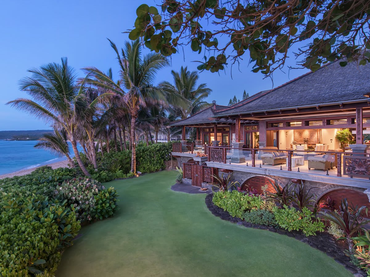 Luxury oceanfront mansion on Oahu's North Shore near Sunset Beach surrounded by tropical vegetation and overlooking the beach