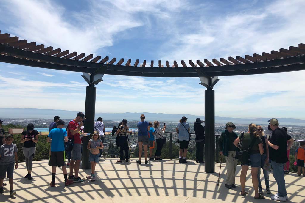 Visitors enjoying panoramic city and mountain views from the California Trail observation deck at Oakland Zoo