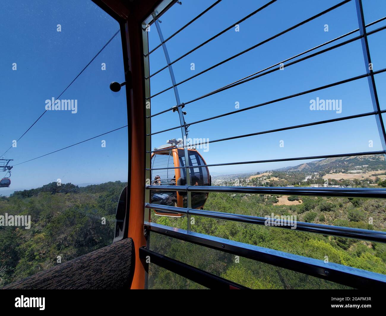 View from inside the Oakland Zoo gondola with surrounding landscape and adjacent gondola car