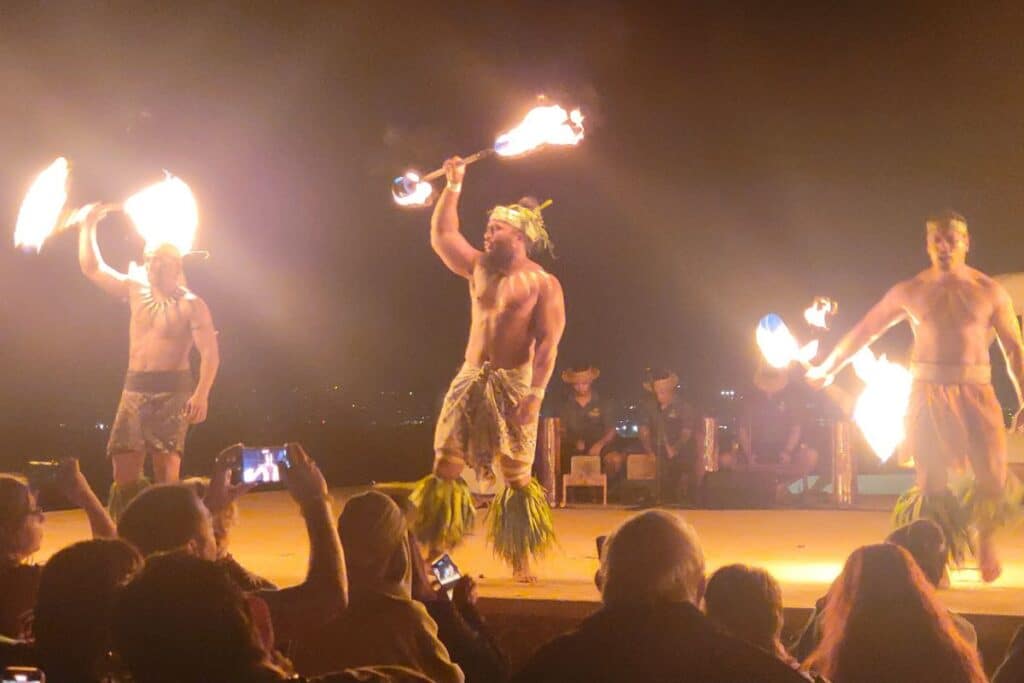 Fire dancers perform at a traditional Hawaiian luau, a popular cultural show featuring flame artistry and Polynesian attire