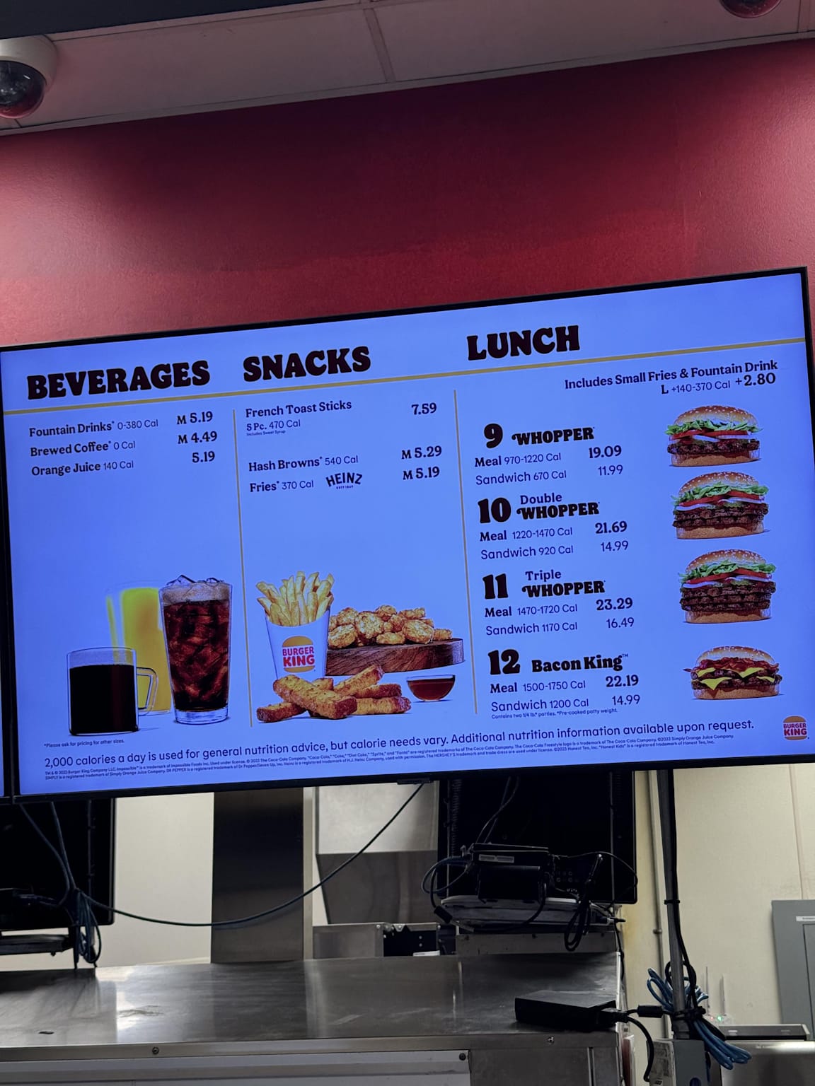 Burger King menu at Honolulu Airport showing prices of beverages, snacks, and Whopper meal options highlighting higher costs for travelers
