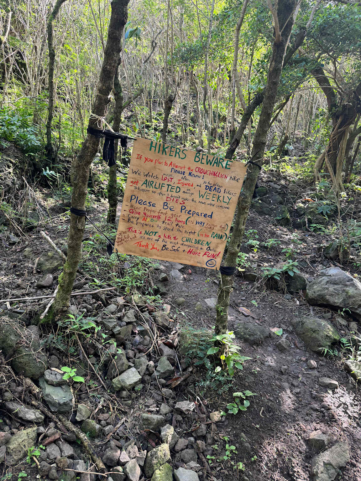warning sign along a Hawaii hiking trail alerts hikers to dangers and warns to be prepared