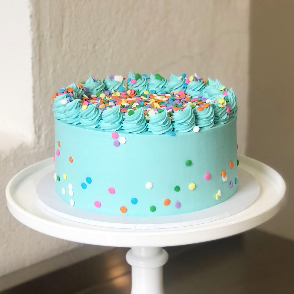 Blue confetti birthday cake with colorful sprinkles
