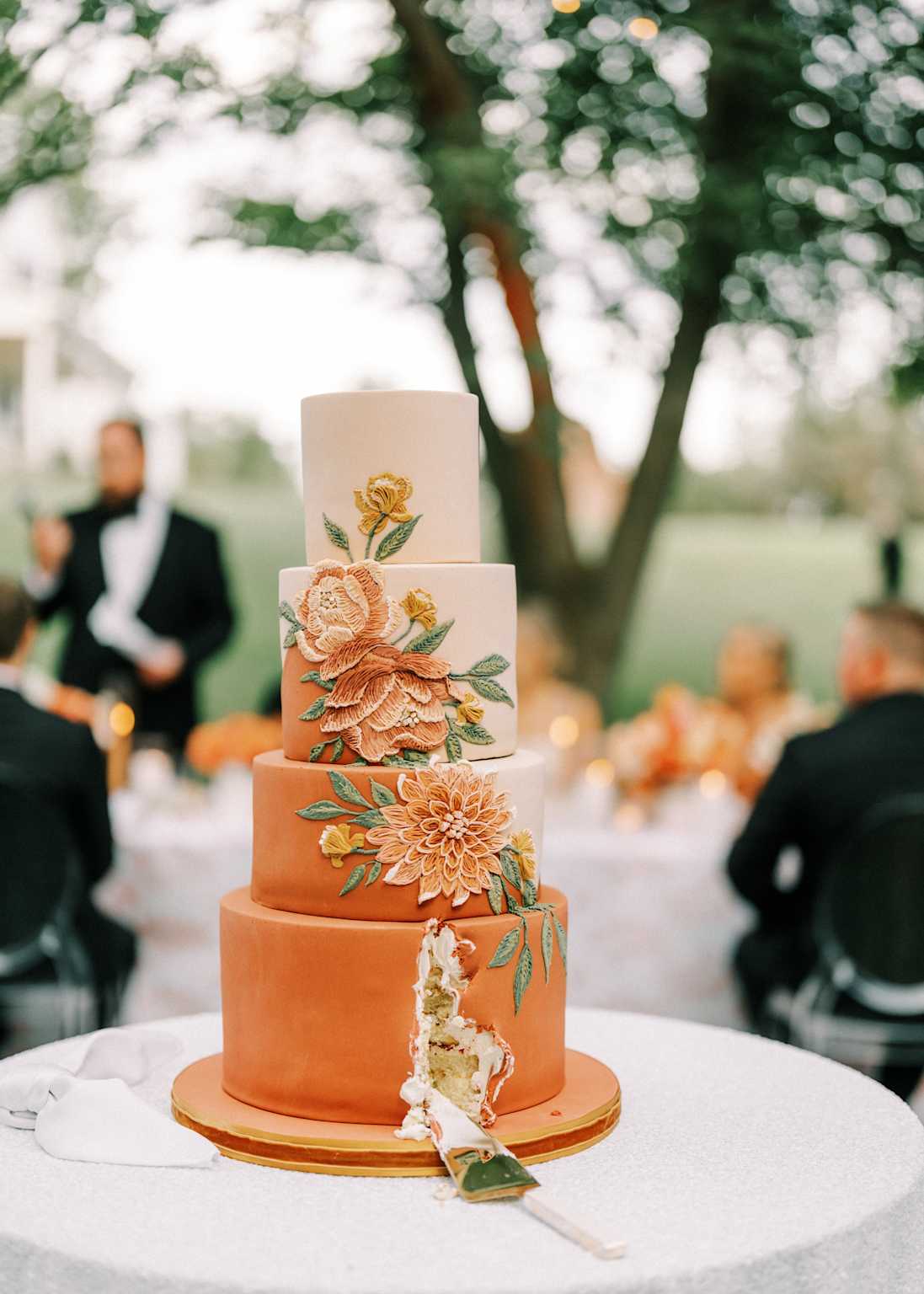 Four-tier wedding cake with floral decorations