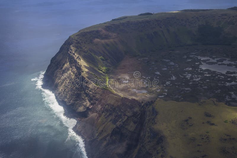 Aerial view of Easter Island’s volcanic crater and coastline showcasing its rugged and remote landscape in the Pacific Ocean