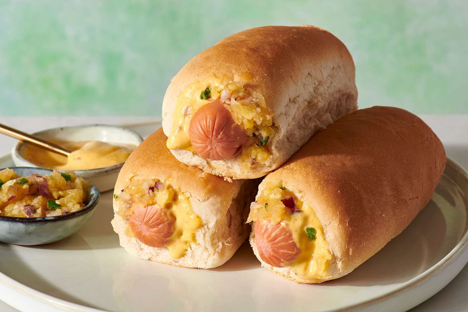 Puka Dogs feature a unique bun with the hot dog inserted through the middle, topped with pineapple, onions, and mustard—a classic Hawaiian street food